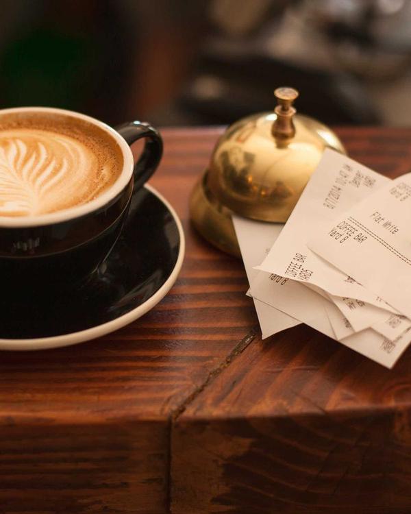 A card with a PayPal QR code on a café counter